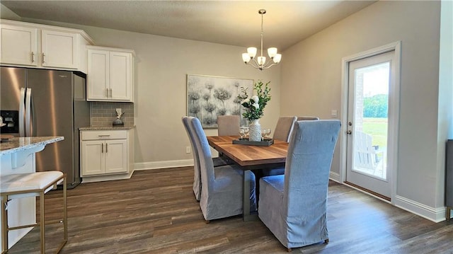 dining room featuring dark wood-type flooring and a chandelier