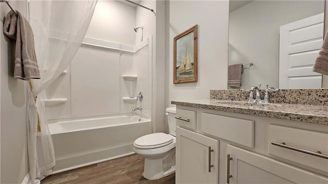 full bathroom with vanity, wood-type flooring, shower / bath combo, and toilet