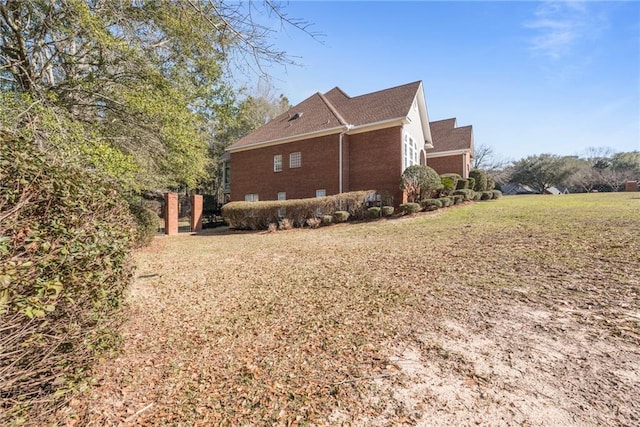 view of home's exterior with a yard