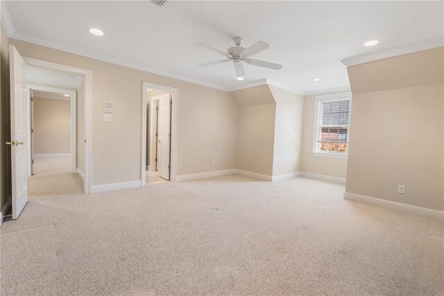 unfurnished room with ceiling fan, ornamental molding, and light colored carpet