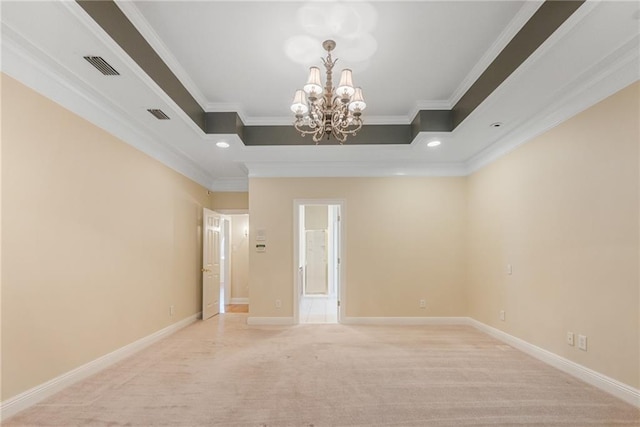 spare room with a notable chandelier, crown molding, light carpet, and a raised ceiling