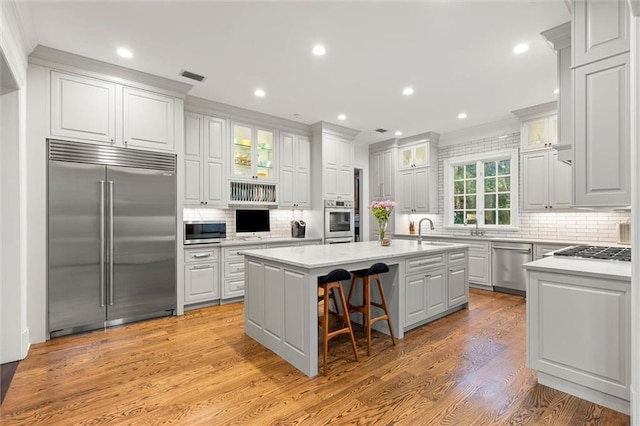 4008 Mcgregor Oaks, Mobile, AL 36608 - kitchen featuring appliances with stainless steel finishes, an island with sink, backsplash, light countertops, and recessed lighting