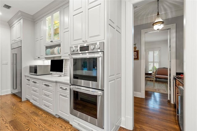4008 Mcgregor Oaks, Mobile, AL 36608 - kitchen with appliances with stainless steel finishes, light wood-style flooring, white cabinetry, light countertops, and glass insert cabinets