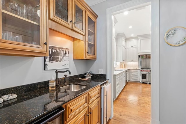 4008 Mcgregor Oaks, Mobile, AL 36608 - kitchen featuring light wood-style floors, decorative backsplash, dark stone counters, wine cooler, and recessed lighting