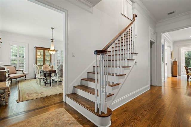 4008 Mcgregor Oaks, Mobile, AL 36608 - stairway with wood finished floors, healthy amount of natural light, crown molding, and a chandelier