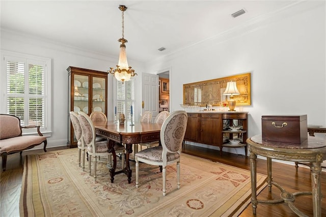 4008 Mcgregor Oaks, Mobile, AL 36608 - dining room featuring a chandelier, wood-type flooring, and ornamental molding