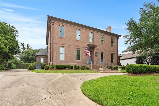 4008 Mcgregor Oaks, Mobile, AL 36608 - view of front facade with a chimney, brick siding, and a front yard