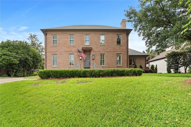 4008 Mcgregor Oaks, Mobile, AL 36608 - view of front facade with a chimney, a front yard, and brick siding