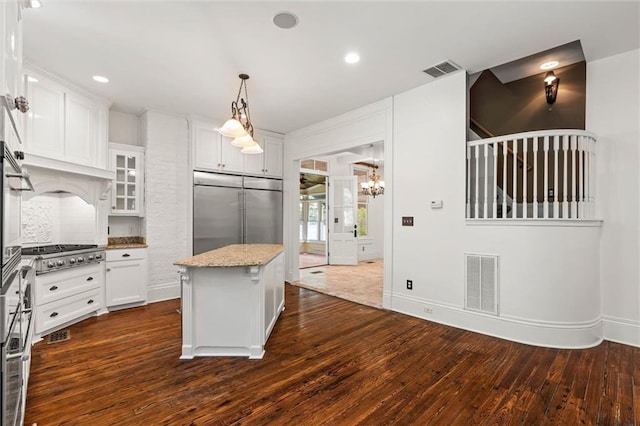 251 Georgia Ave S, Mobile, AL 36604 - kitchen featuring a center island, dark wood-style floors, visible vents, light stone counters, and appliances with stainless steel finishes