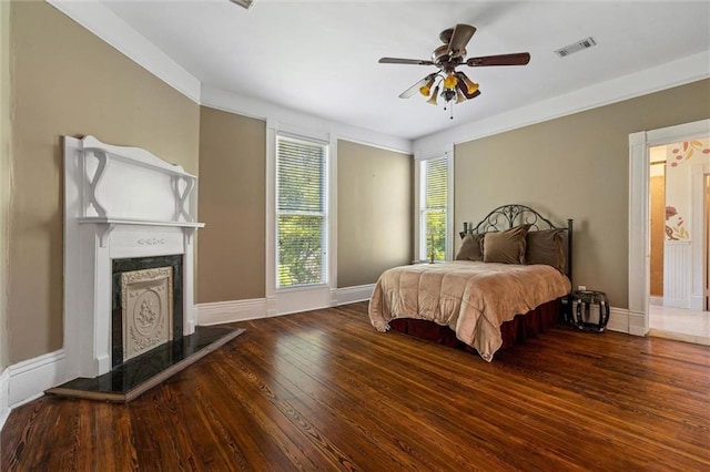 251 Georgia Ave S, Mobile, AL 36604 - bedroom featuring visible vents, baseboards, a fireplace, hardwood / wood-style flooring, and ceiling fan