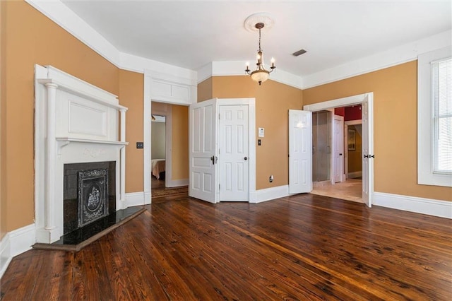 251 Georgia Ave S, Mobile, AL 36604 - unfurnished living room with a high end fireplace, wood finished floors, visible vents, baseboards, and a chandelier