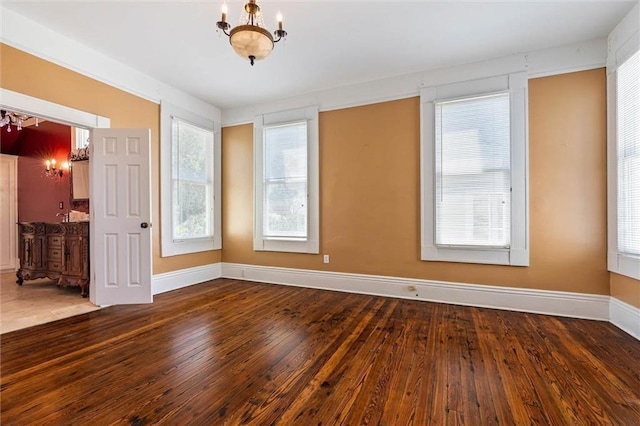 251 Georgia Ave S, Mobile, AL 36604 - spare room featuring hardwood / wood-style floors, baseboards, and a notable chandelier