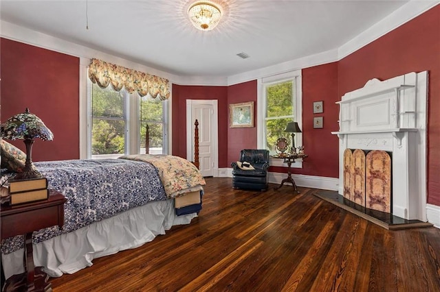 251 Georgia Ave S, Mobile, AL 36604 - bedroom featuring baseboards, hardwood / wood-style floors, visible vents, and a fireplace