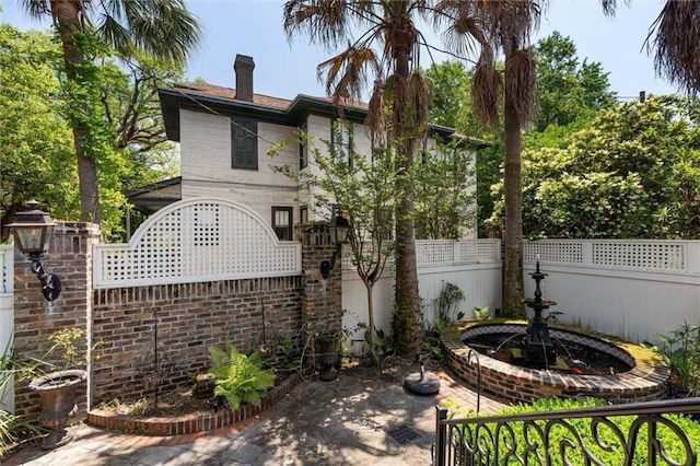 251 Georgia Ave S, Mobile, AL 36604 - rear view of house with a chimney and fence