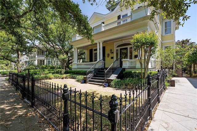 251 Georgia Ave S, Mobile, AL 36604 - victorian house featuring a porch, stairway, and a fenced front yard
