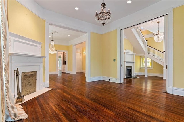 251 Georgia Ave S, Mobile, AL 36604 - unfurnished living room with a fireplace with flush hearth, wood finished floors, and a chandelier