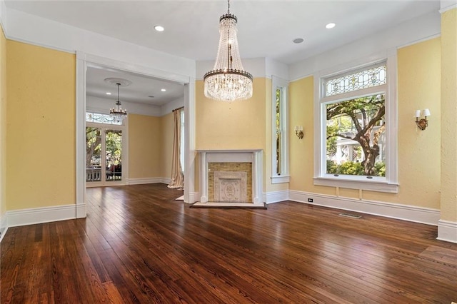 251 Georgia Ave S, Mobile, AL 36604 - unfurnished living room featuring hardwood / wood-style floors, baseboards, and a notable chandelier