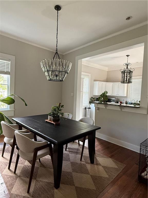 1367 Brown St, Mobile, AL 36604 - dining space featuring a chandelier, dark wood-style flooring, and ornamental molding