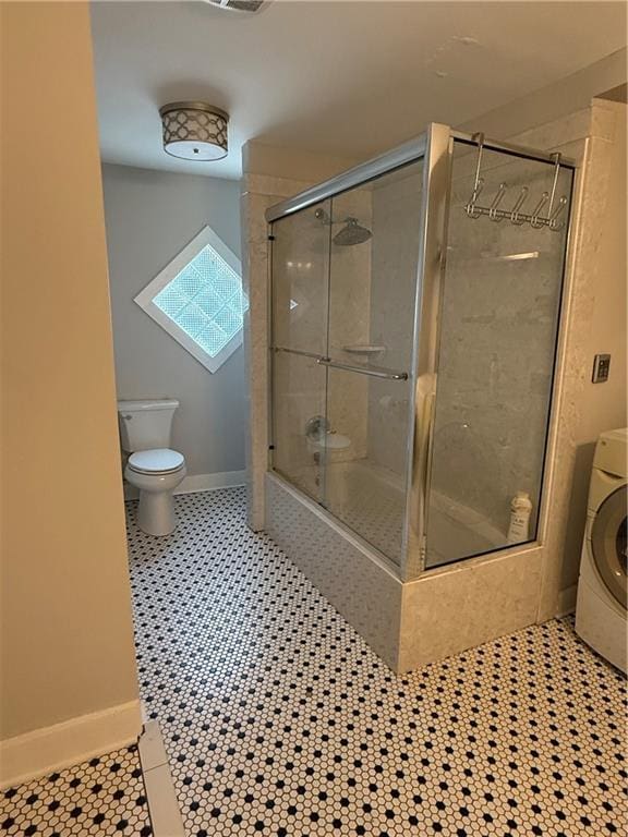 1367 Brown St, Mobile, AL 36604 - bathroom featuring washer / dryer, a tile shower, and tile patterned floors