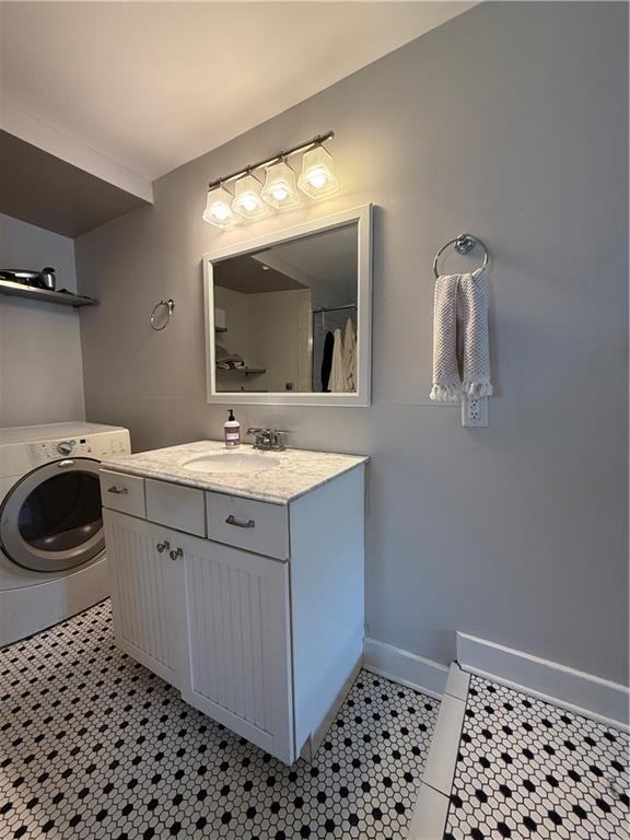 1367 Brown St, Mobile, AL 36604 - bathroom featuring washer / dryer, vanity, and tile patterned floors