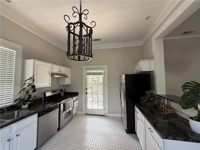 1367 Brown St, Mobile, AL 36604 - kitchen with appliances with stainless steel finishes, white cabinetry, ornamental molding, under cabinet range hood, and pendant lighting