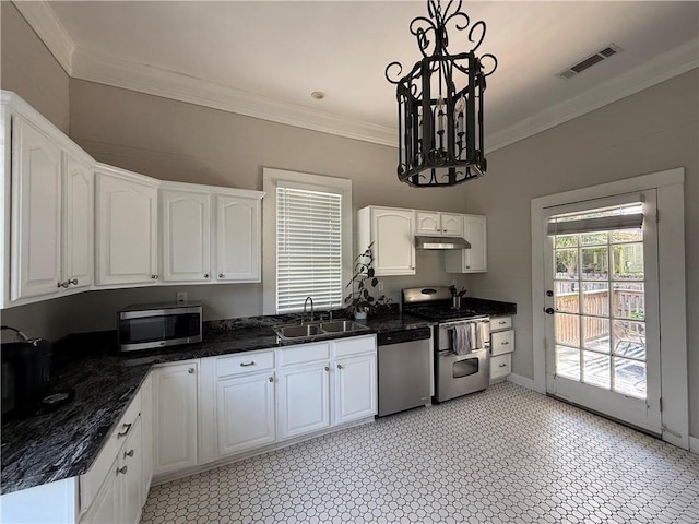 1367 Brown St, Mobile, AL 36604 - kitchen with stainless steel appliances, crown molding, white cabinetry, hanging light fixtures, and under cabinet range hood