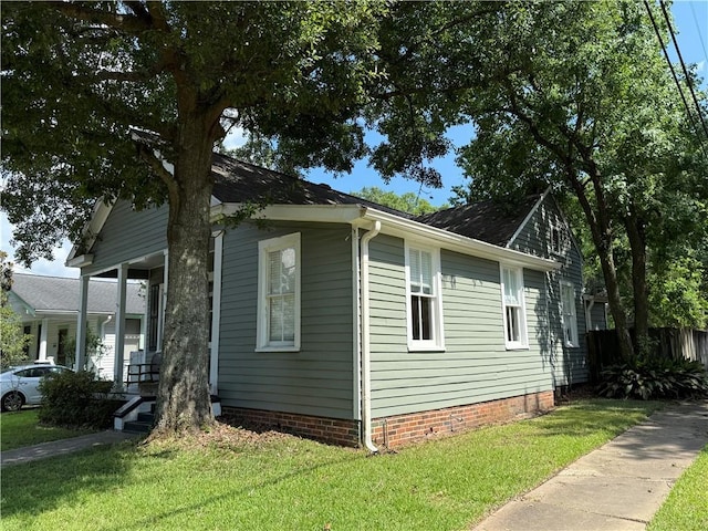 1367 Brown St, Mobile, AL 36604 - view of side of property featuring a yard and a shingled roof