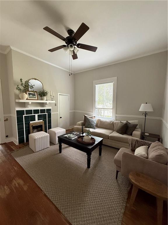 1367 Brown St, Mobile, AL 36604 - living area with wood finished floors, ceiling fan, crown molding, and a fireplace