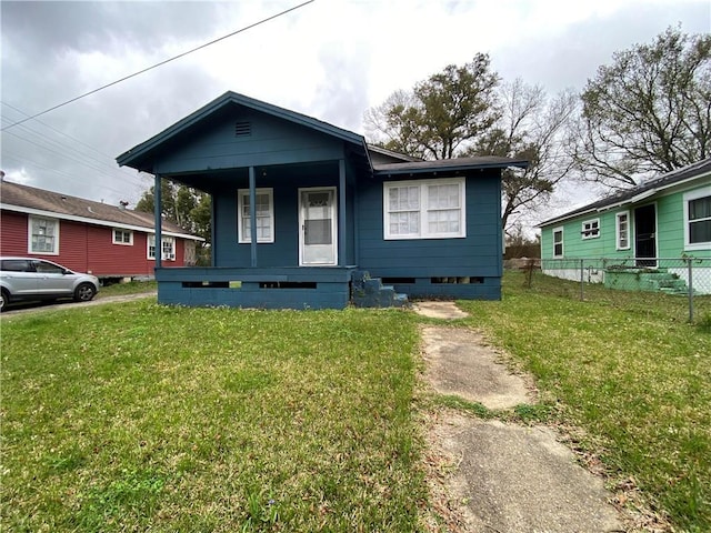 bungalow-style home with covered porch and a front yard