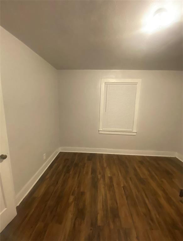 additional living space with dark hardwood / wood-style flooring