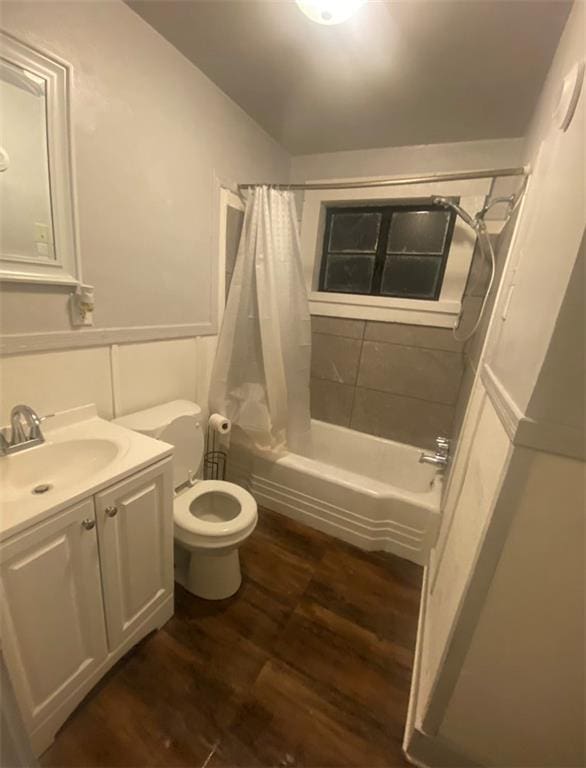 full bathroom featuring toilet, vanity, shower / bath combination with curtain, and hardwood / wood-style flooring