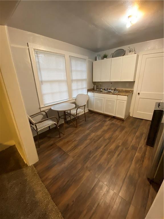 kitchen with white cabinets, dark hardwood / wood-style floors, and sink