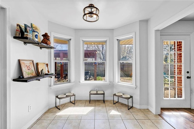 interior space featuring light tile patterned floors and baseboards