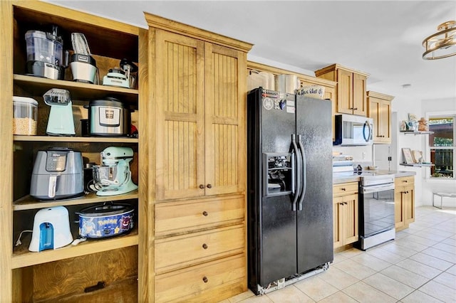 kitchen featuring light tile patterned floors, stainless steel appliances, light countertops, and light brown cabinetry