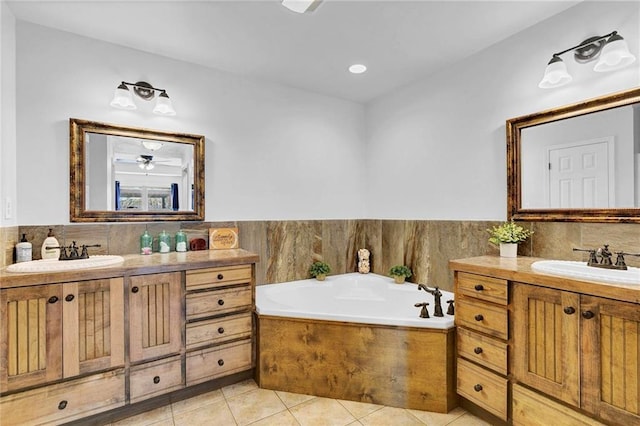 bathroom with tile patterned flooring, two vanities, and a sink