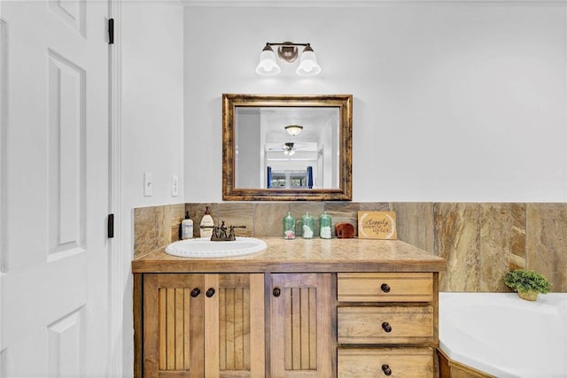 bathroom featuring a garden tub and vanity