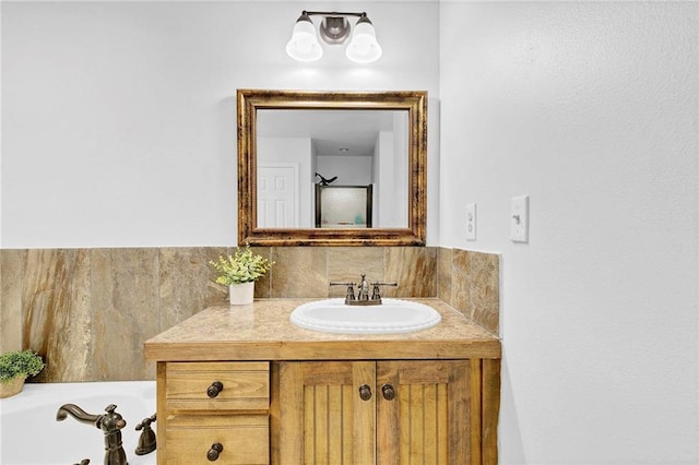 full bathroom featuring a washtub and vanity