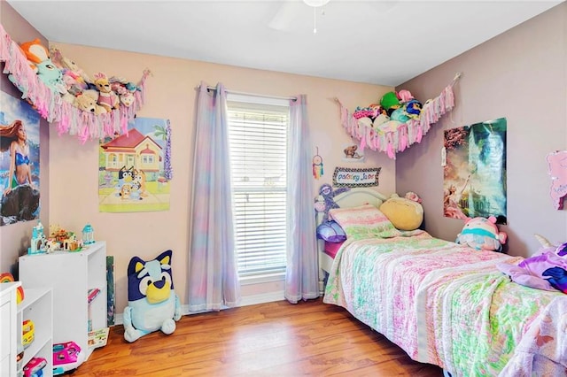 bedroom featuring baseboards, a ceiling fan, and wood finished floors