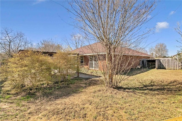 view of side of home with brick siding