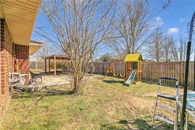 view of yard with a patio, a playground, a fenced backyard, and a gazebo