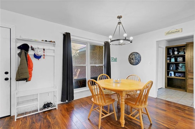 dining space with a chandelier and wood finished floors