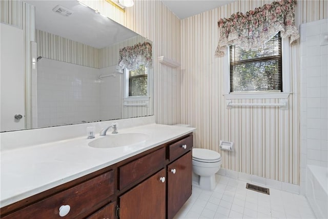 bathroom featuring a wealth of natural light, vanity, visible vents, and wallpapered walls