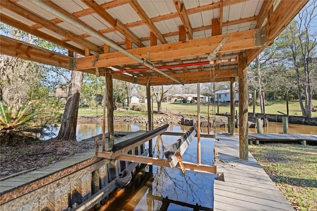 dock area with a water view and boat lift