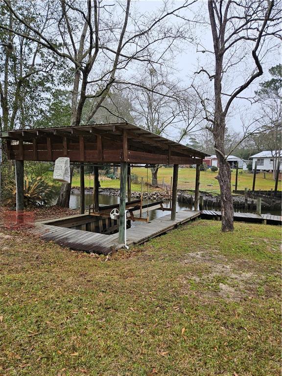 exterior space with a water view and a lawn