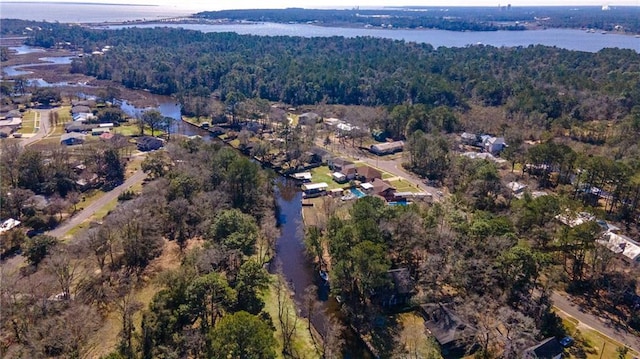 aerial view featuring a water view and a forest view