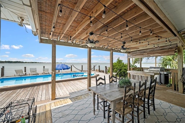 view of patio / terrace with a ceiling fan, outdoor dining area, a grill, and an outdoor pool