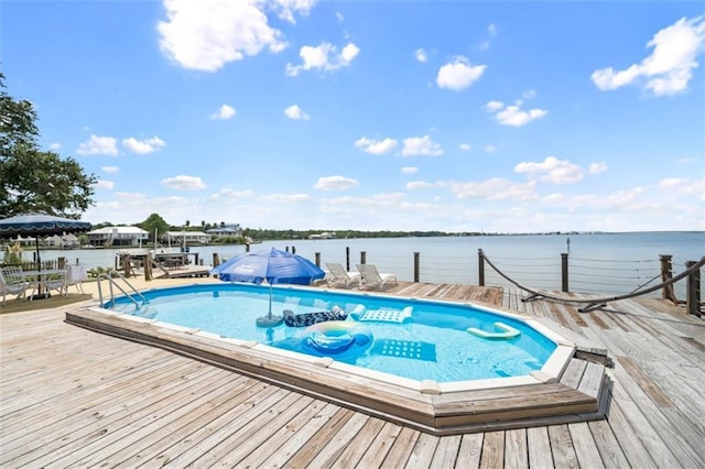 view of pool featuring a boat dock and a water view