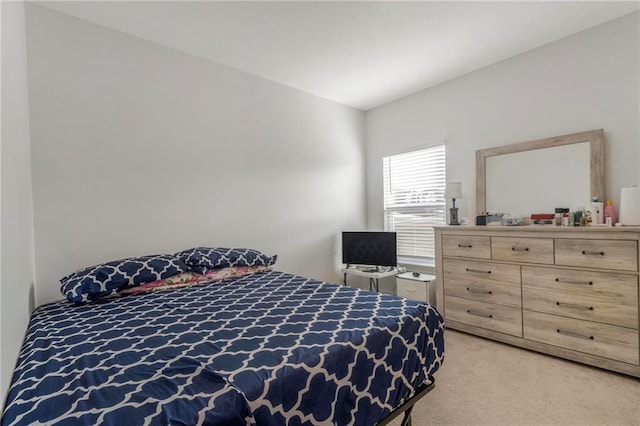 bedroom featuring light carpet and vaulted ceiling