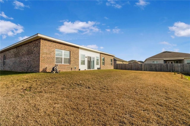 back of house featuring a yard