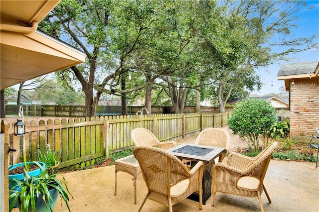 view of patio featuring an outdoor fire pit and a fenced backyard